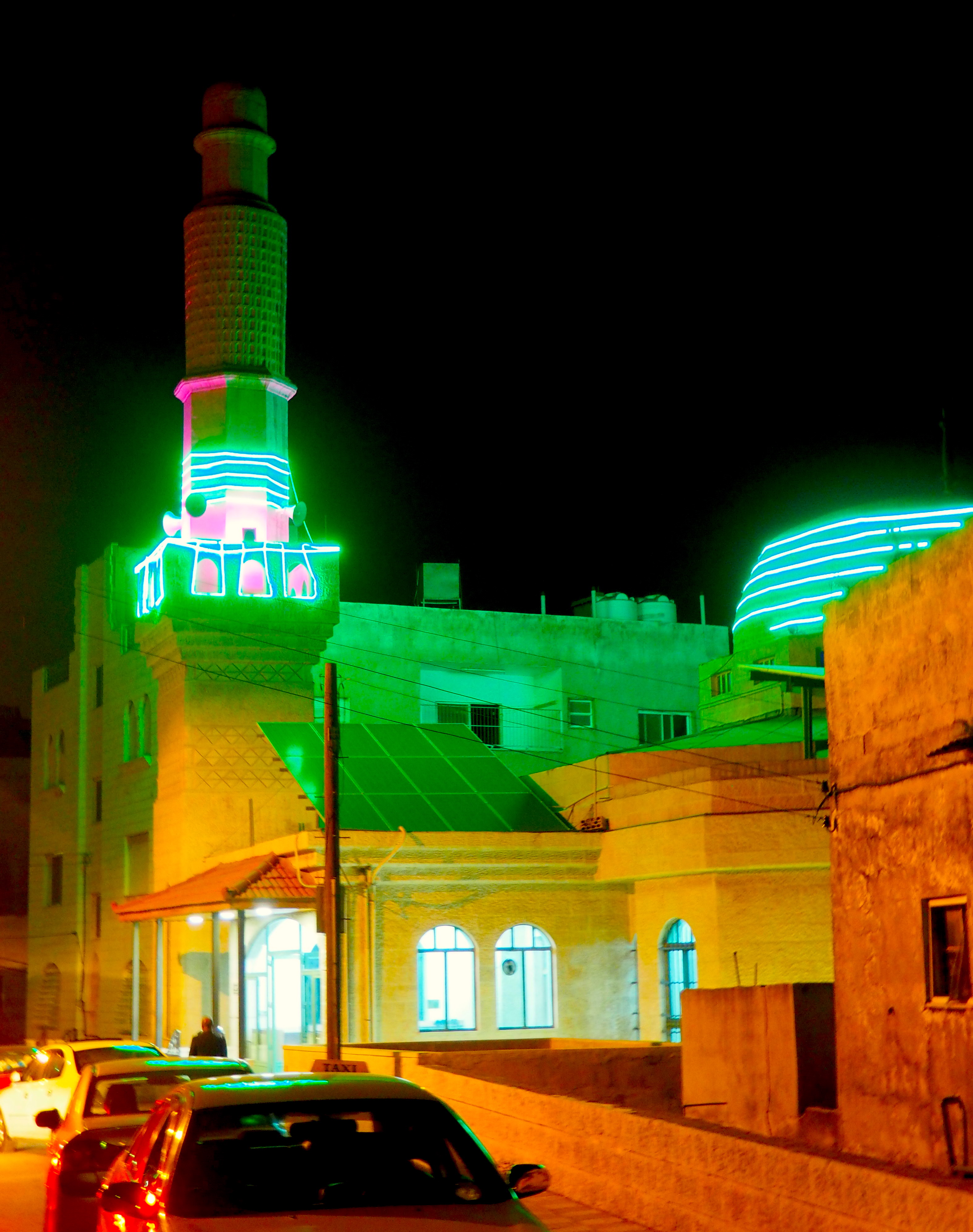 The green glowing lights of a mosque in Amman, Jordan